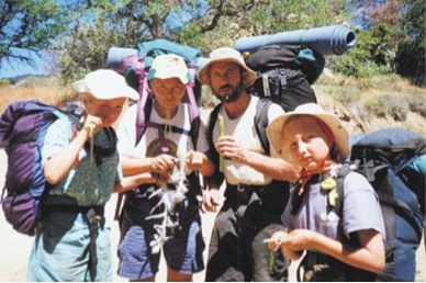 Raw Family Hiking and Eating Wild Thistle